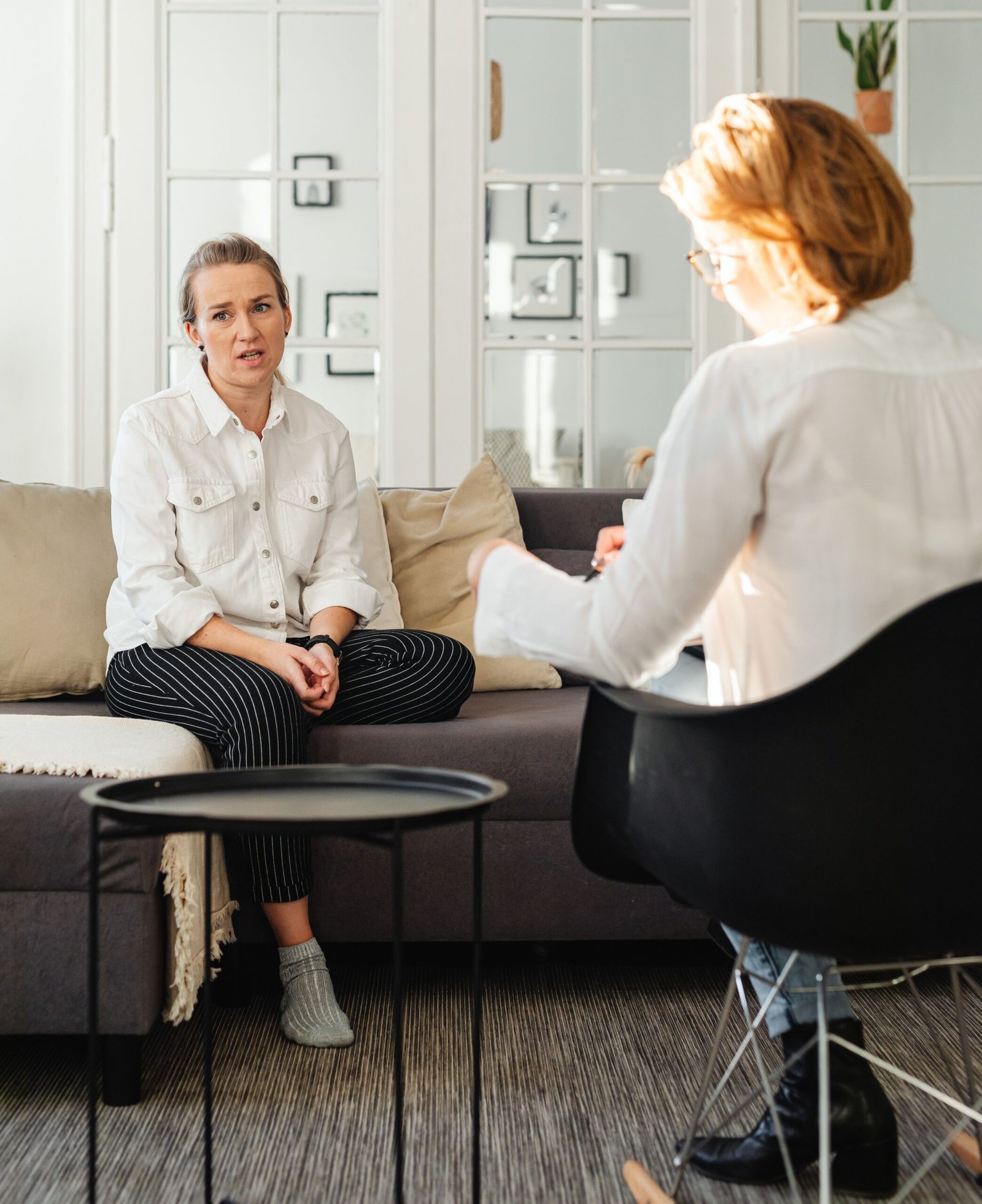 Behavioral health professional speaking with an adult in a calm counseling environment
